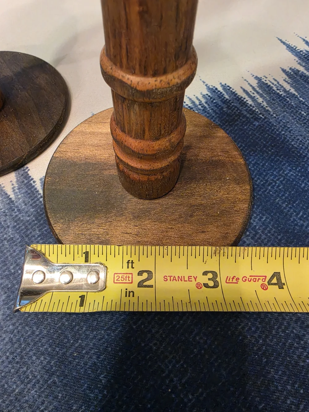 Trio Of Turned dark wood candlestick holders pastel-colored sculpted floral cups